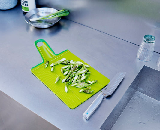 [hidden] [lifestyle] Chop2Pot™ Plus Folding Chopping Board - Green - Image 1